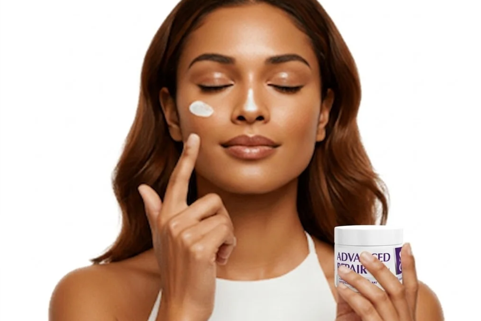 A close-up studio portrait of a smiling woman with medium-toned skin and closed eyes, applying skincare product. She is holding a white jar labeled 'ADVANCED REPAIR CREAM' with purple branding in her left hand, while her right index finger gently touches a small dab of white cream on her cheek. Another dab of cream is visible on the bridge of her nose. The background is a clean, solid white.